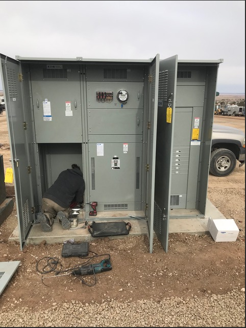 Commercial electrical enclosure service work on job site